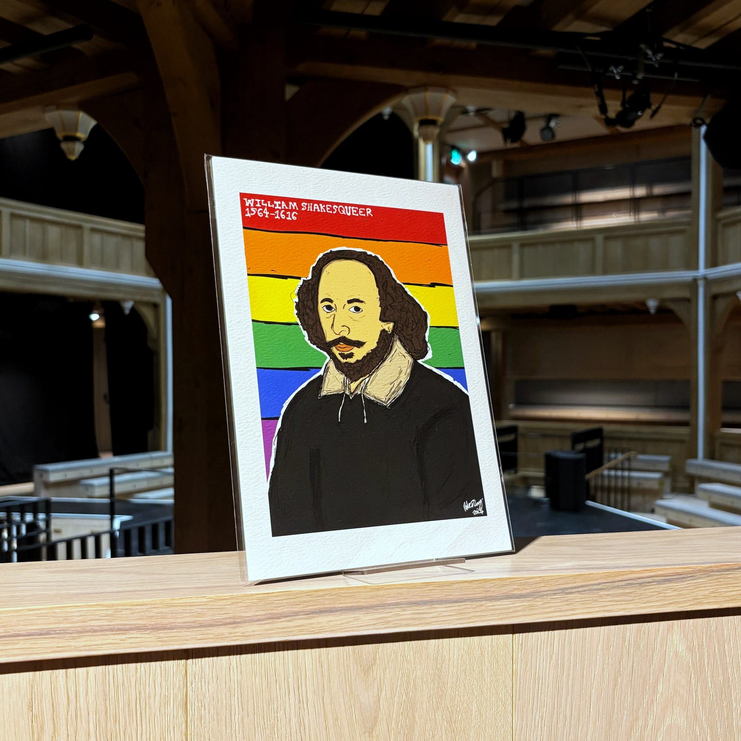 A print featuring an image of William Shakespeare against a backdrop of the pride flag. Illustrated by Peter Eric Lang.