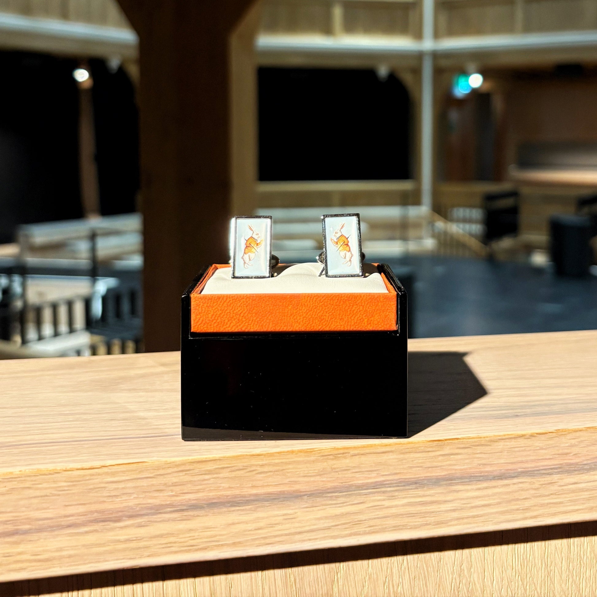 Cufflinks featuring an illustration of the White Rabbit from Alice in Wonderland.