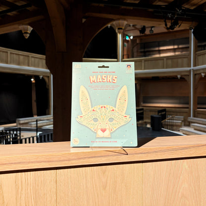 Pack of masks on a wooden ledge with a theater interior in the background