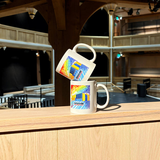 Two mugs stacked, each features a rainbow illustration of the Shakespeare North building