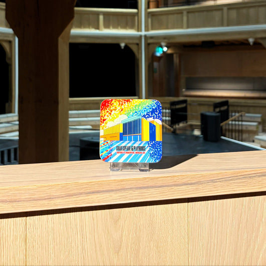 A coaster featuring a rainbow illustration of the Shakespeare North building